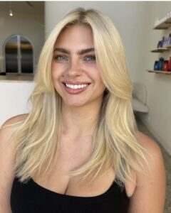 Woman with freshly foiled hair, showcasing the 'Blonde Foiled Queen' service at Kasey Lee Blonde Specialist.