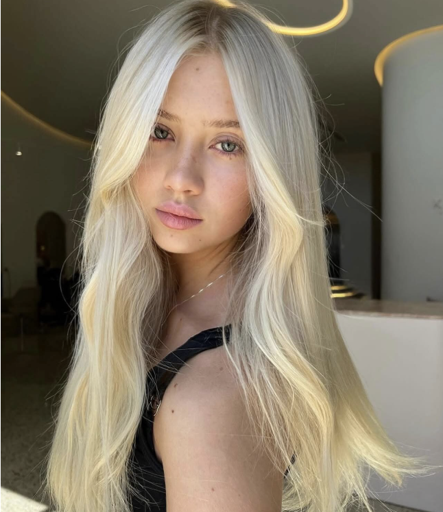 Wavy long blonde hair styled to the side, featuring the Platinum Blonde Service by blonde hairdresser in Melbourne.